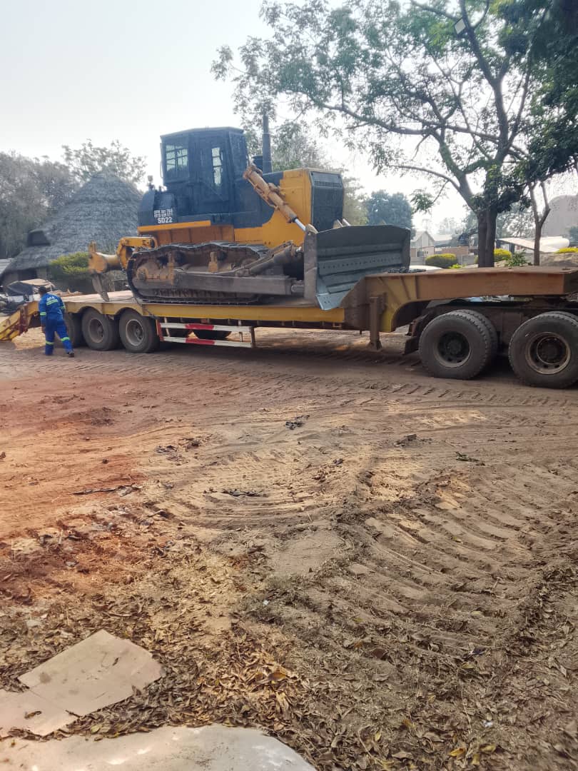 Bulldozer being transported on lowbed trailer