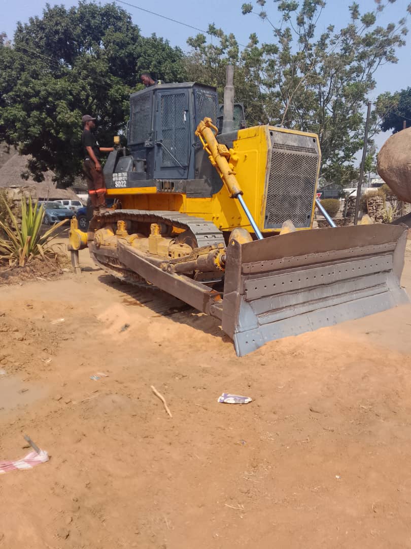 Bulldozer with operator on sandy construction site